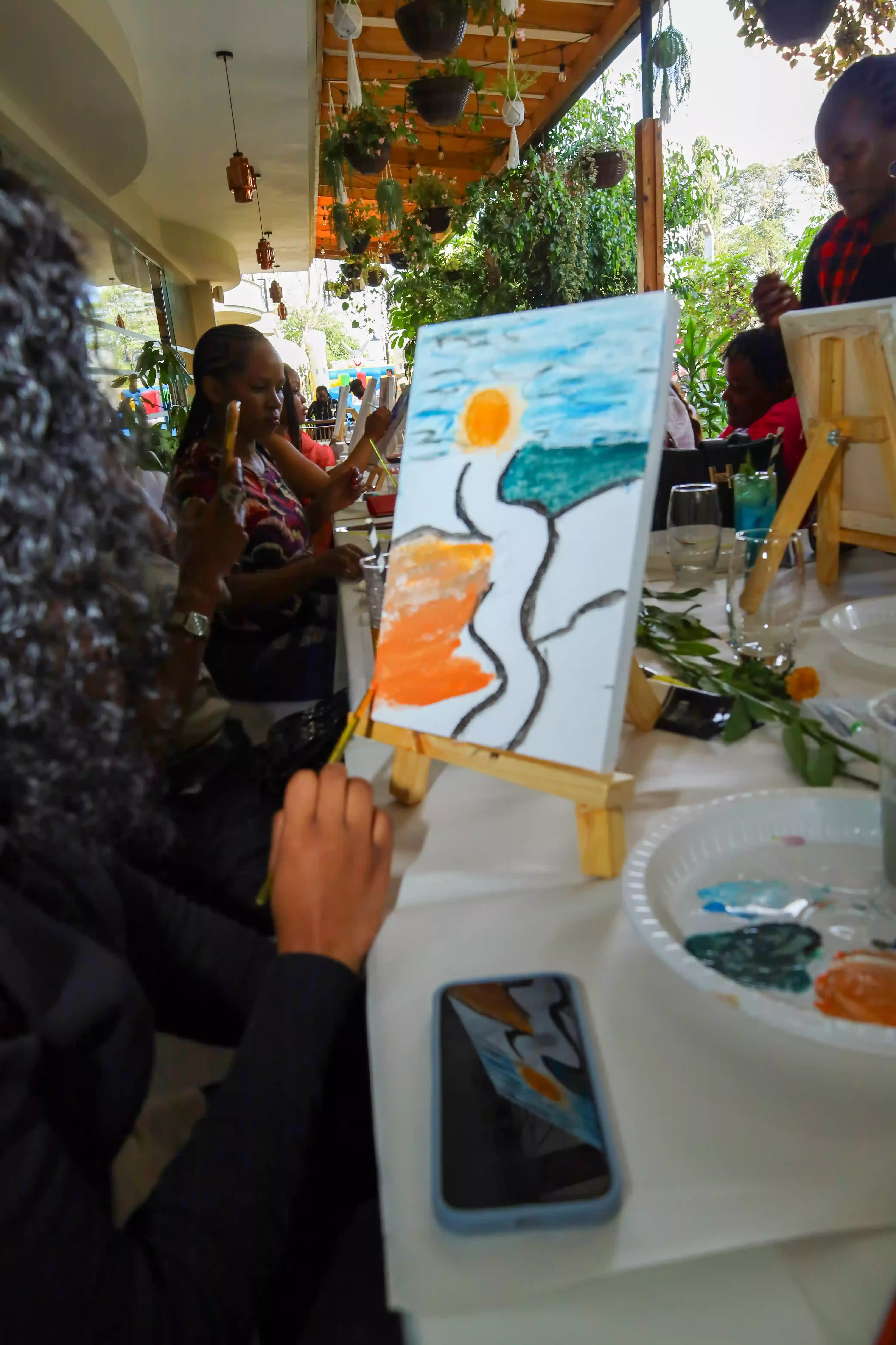 Guests painting and enjoying wine at Alba Hotel